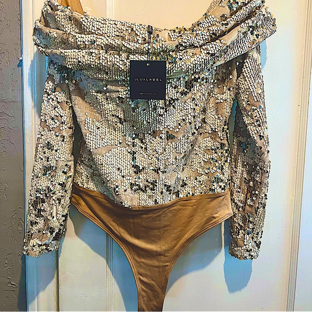 Elegant off-shoulder bodysuit w/folded neckline and ruched shoulders.